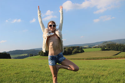 Elke doing nude yoga on a field in Sauerland photo 05